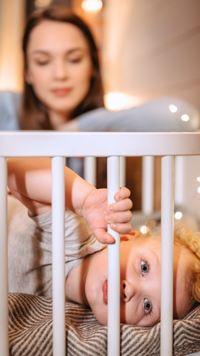 Parent with alert toddler during bedtime routine sleep coaching