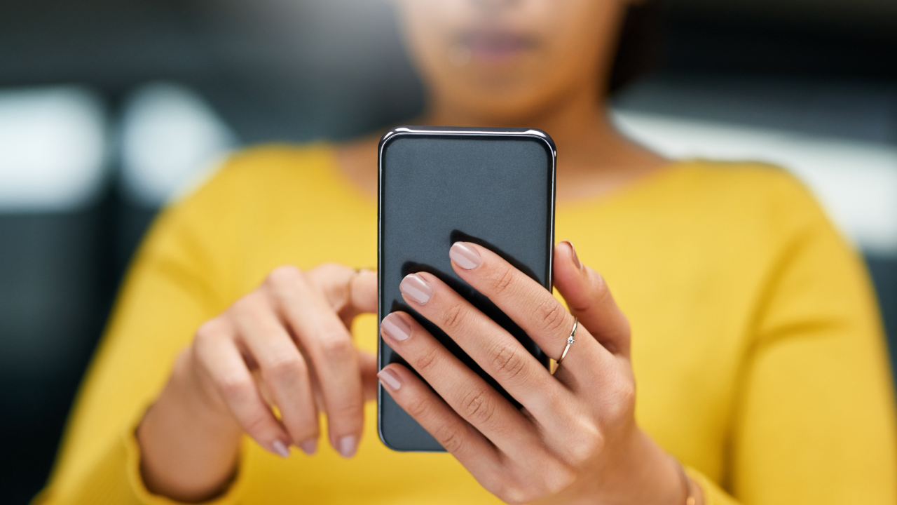 Person scrolling on their phone not listening.