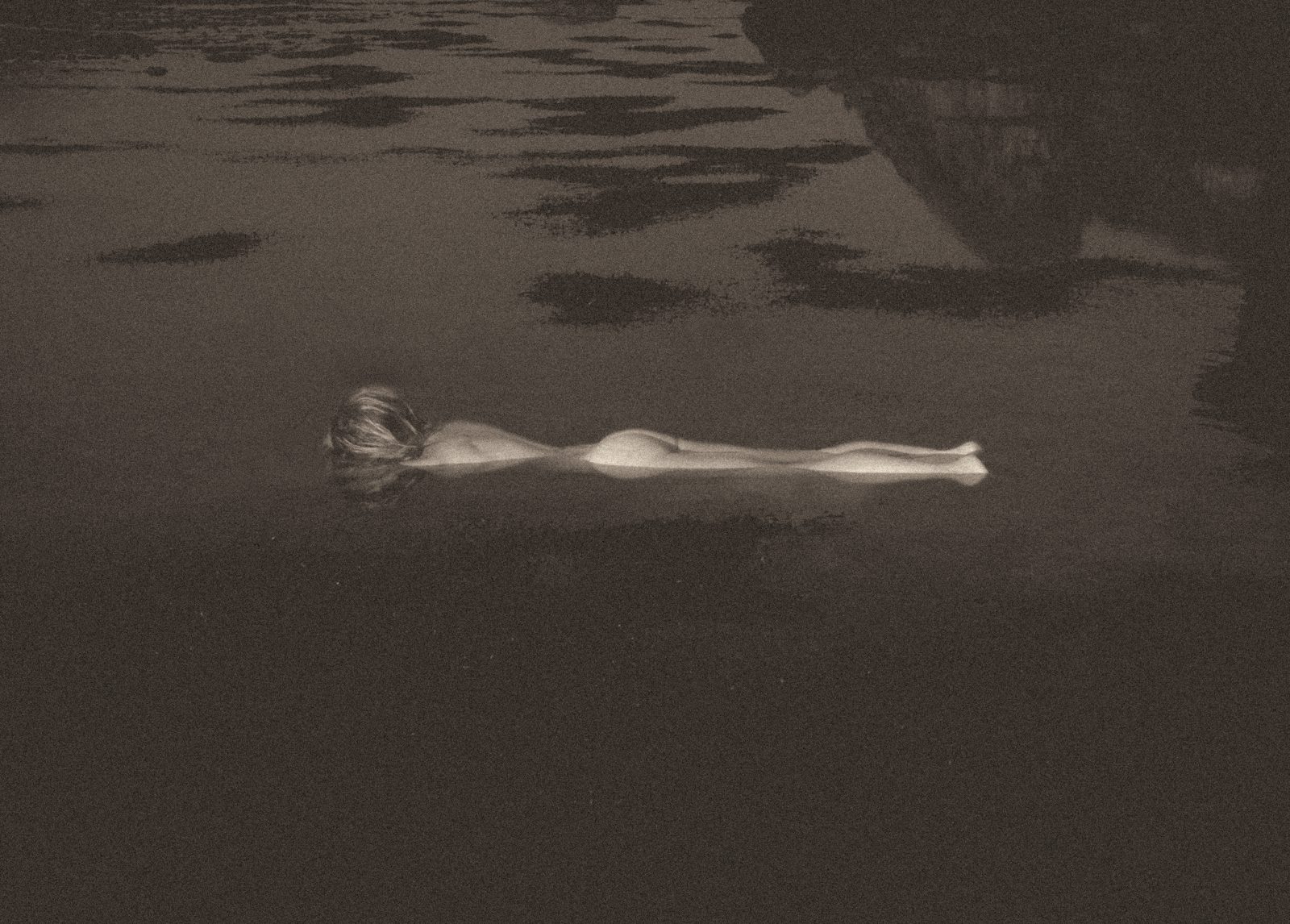 A body floating in dark water
