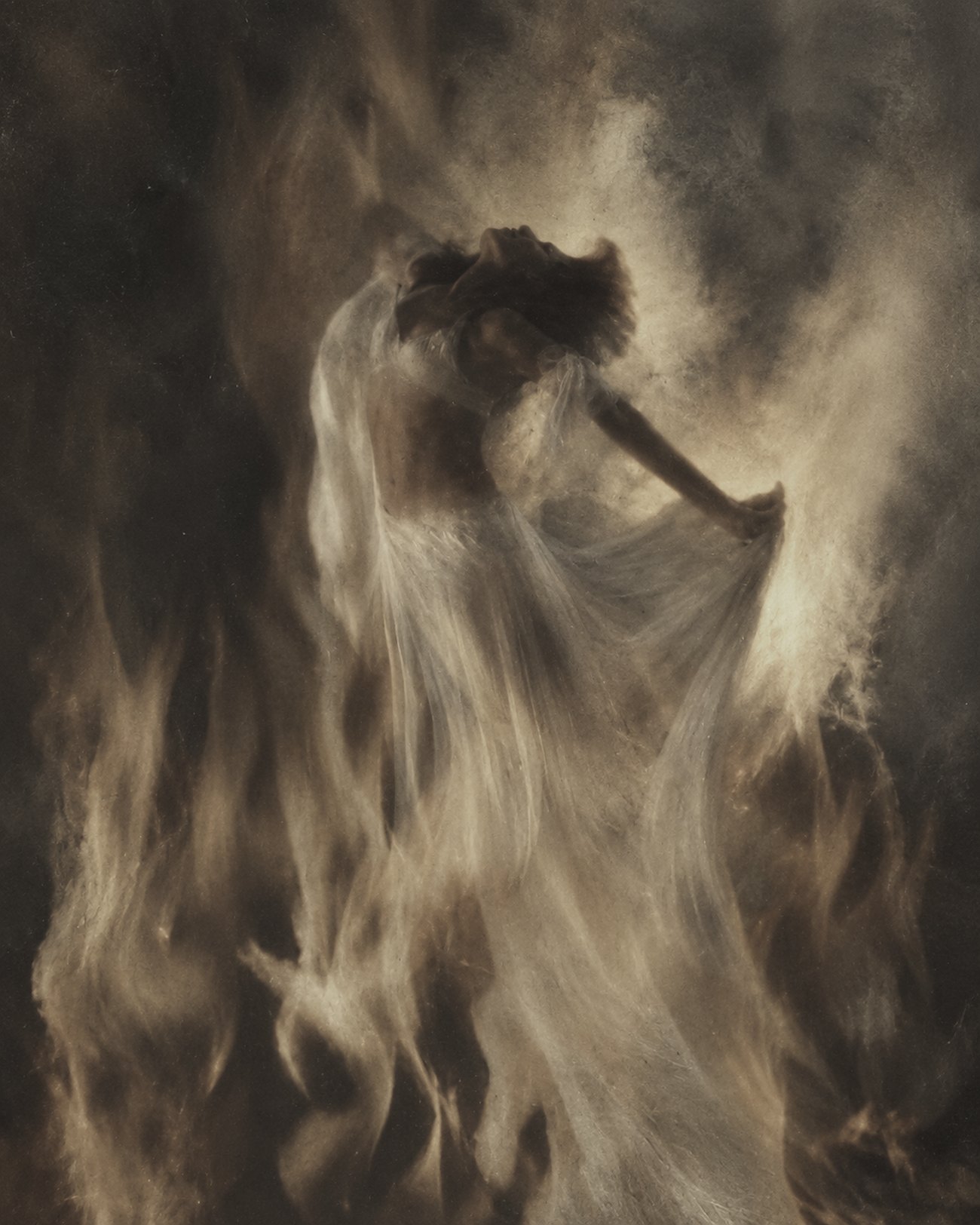A woman dancing in firelight