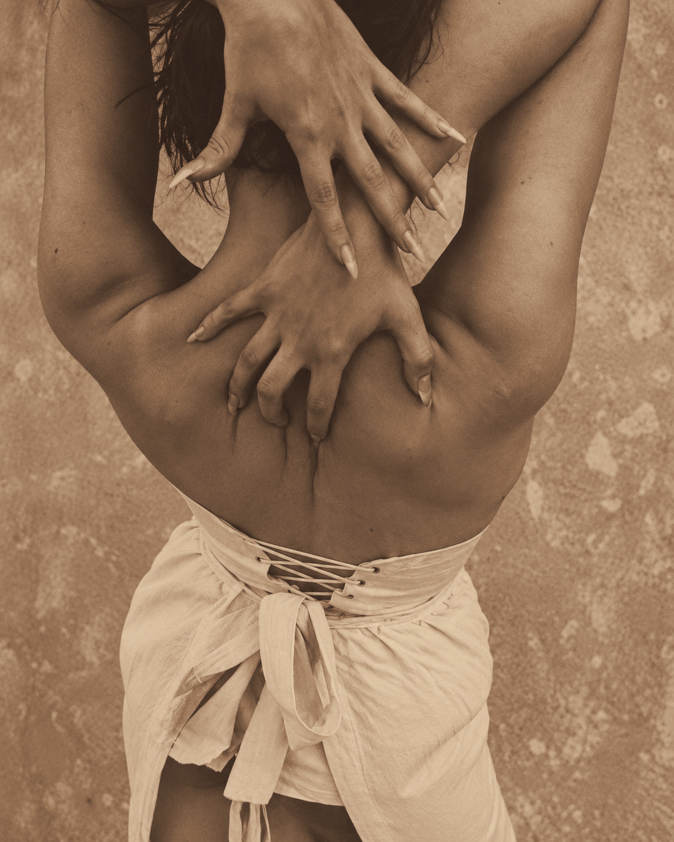 Hands resting on a bare back