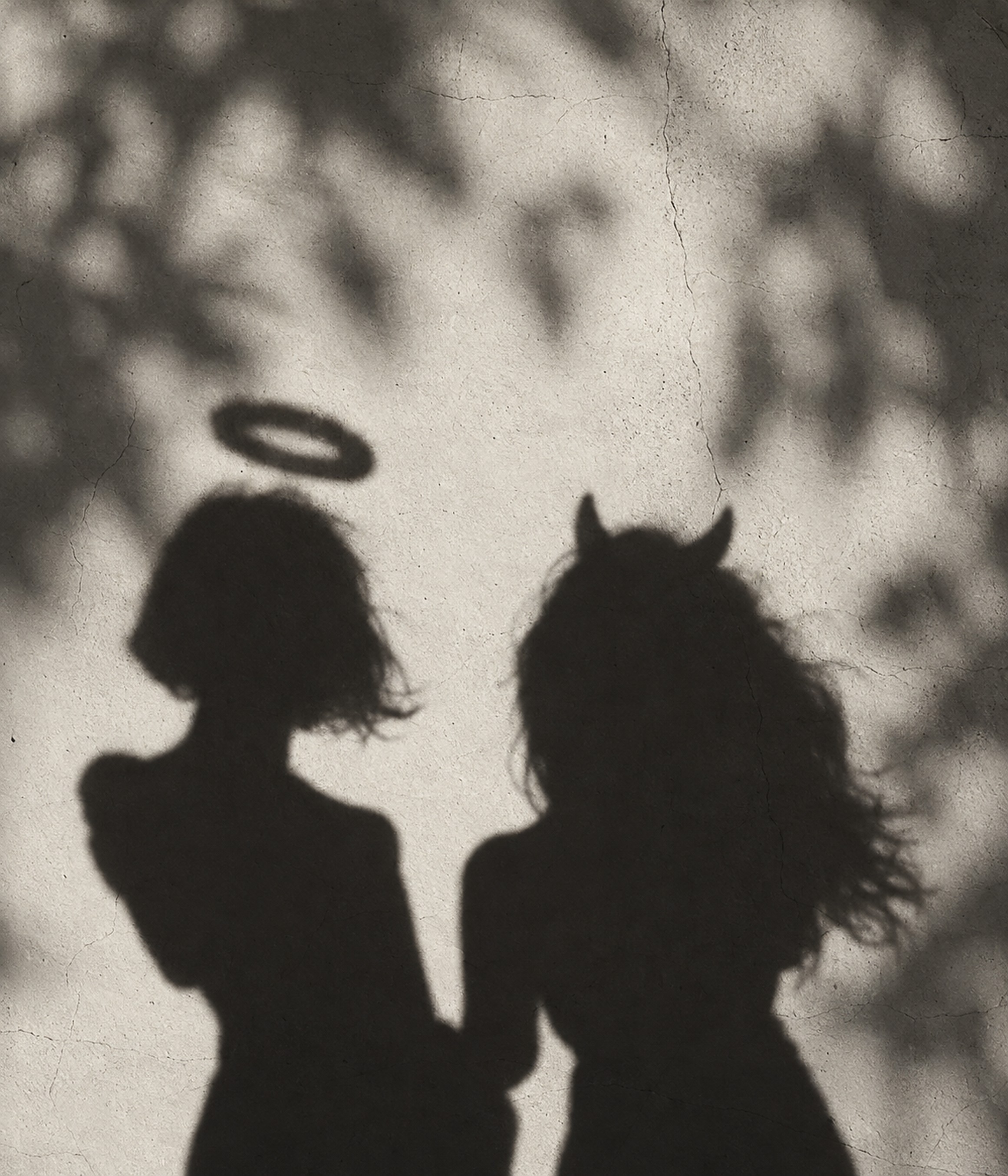The shadows of an angel and a devil