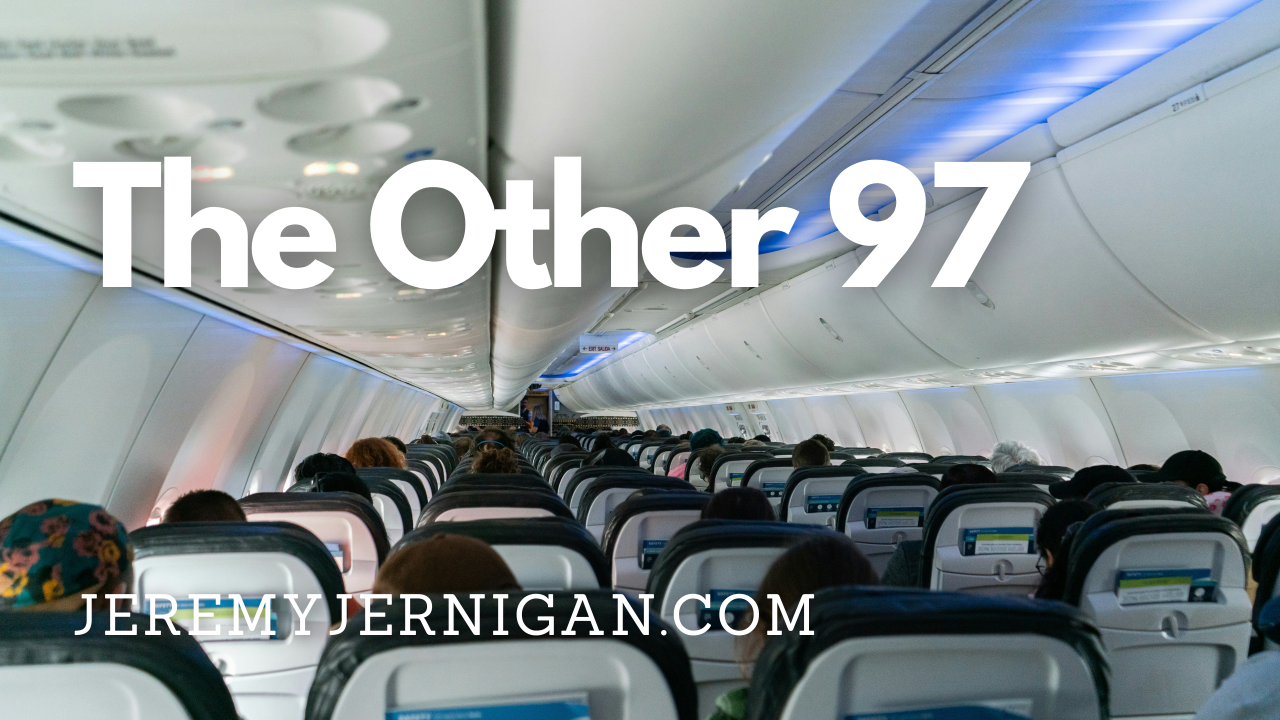 View from the back of a full airplane cabin, rows of seated passengers under blue lighting, with the title "The Other 97" overlaid.
