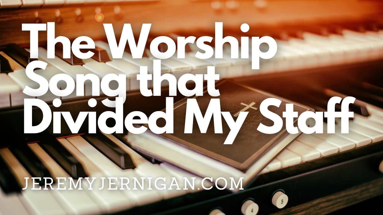 Bible with a cross on the cover resting open on piano and organ keys, with the title "The Worship Song that Divided My Staff"