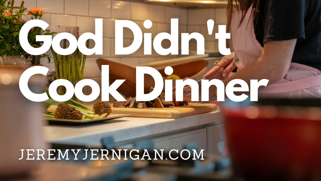 Blog post header image for "God Didn't Cook Dinner" by Jeremy Jernigan at JeremyJernigan.com, featuring a woman preparing food at a kitchen counter with fresh vegetables and a cutting board.