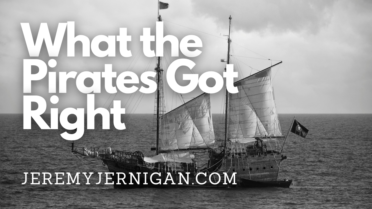 Black-and-white photo of a two-masted tall ship sailing on open water under a cloudy sky, with the blog post title "What the Pirates Got Right" over it.