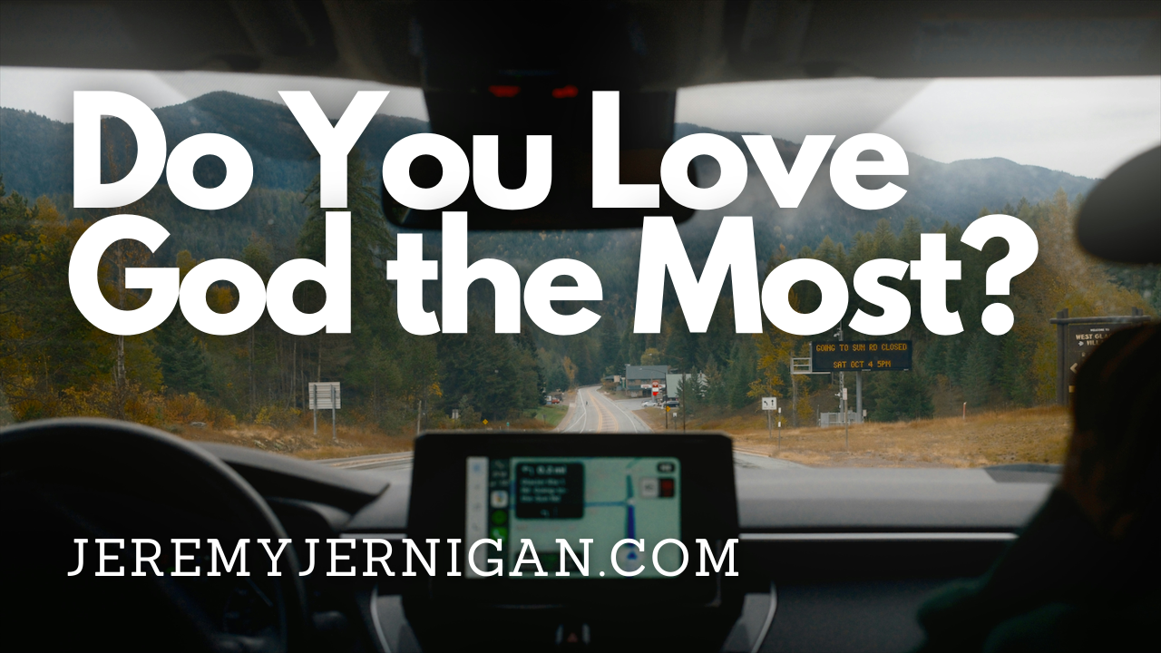 View through a car windshield of a forested mountain road, with the dashboard navigation screen visible and the title "Do You Love God the Most?" overlaid