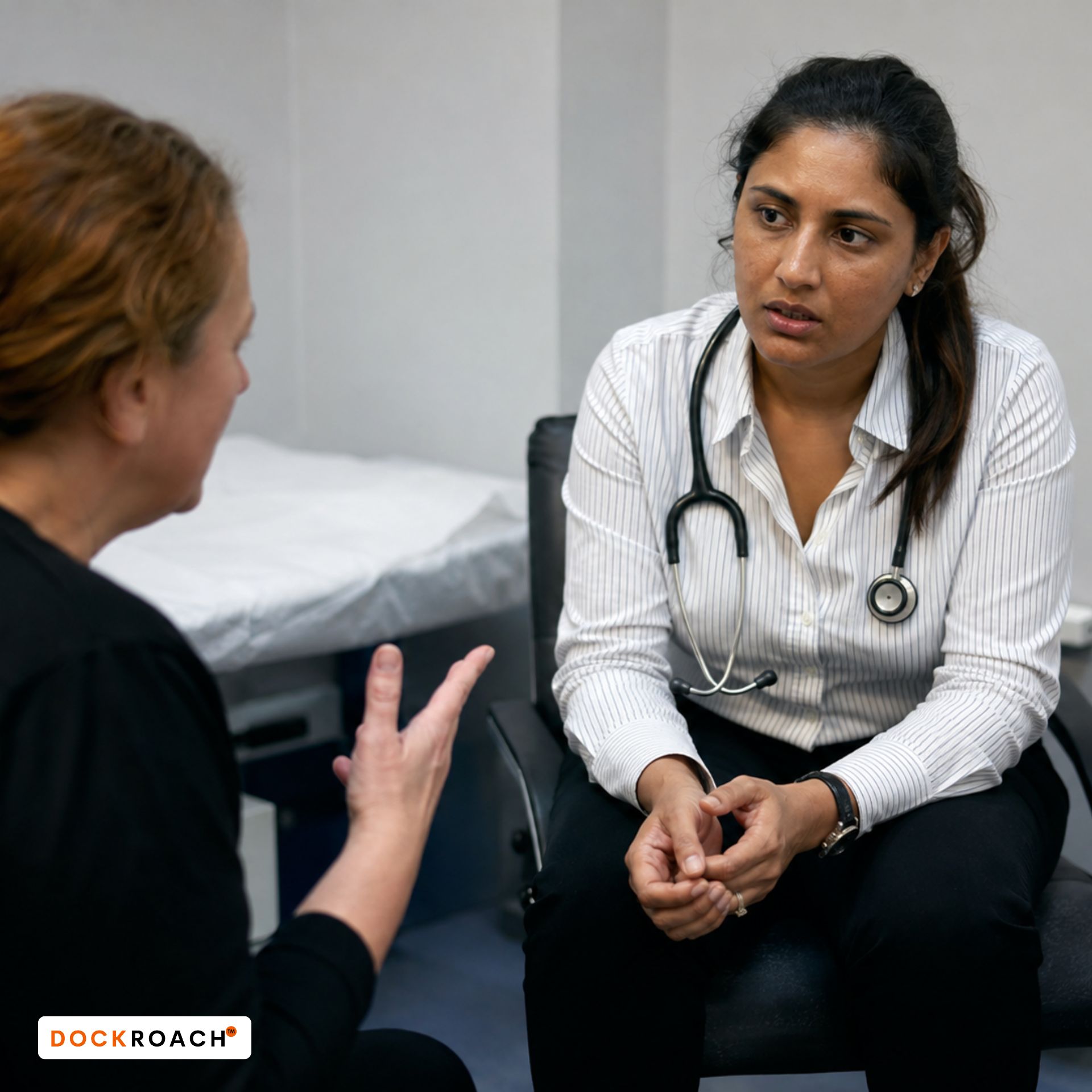 Fear Changes What the Examiner Sees International medical graduate listening to an emotionally engaged patient during a clinical consultation, showing the pressure of maintaining structure and composure in the AMC Clinical Exam.