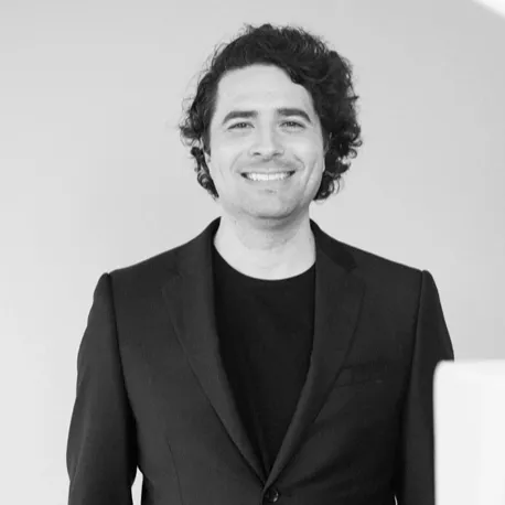 Picture of a man smiling infront of a white backdrop