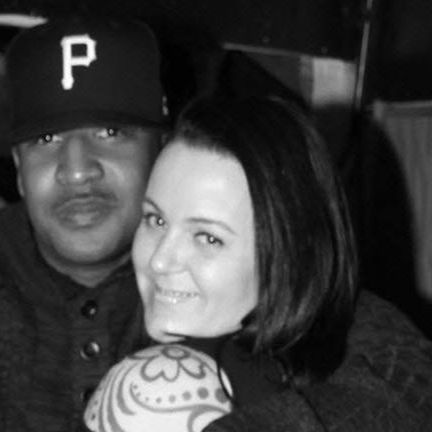 Photo of a woman holding being hugged by a man