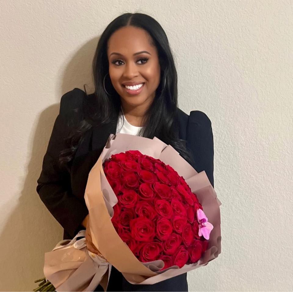 Photo of a woman holding red roses
