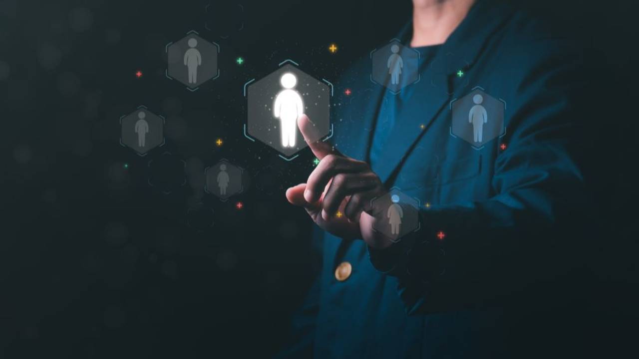 A business leader selecting an EOS Integrator from a digital network of candidate profiles, symbolising fast, direct access to integrator talent without intermediaries.