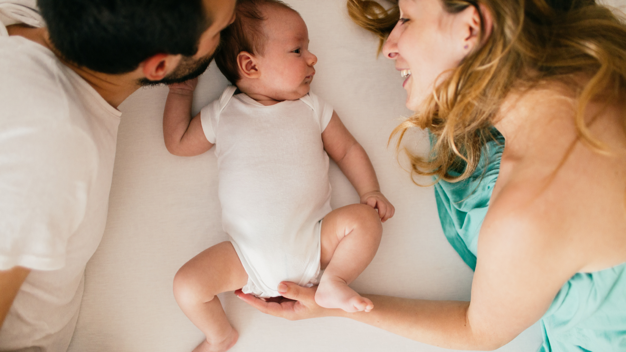 New parents spending quiet connection time with their baby to support bonding, emotional safety, and early brain development.