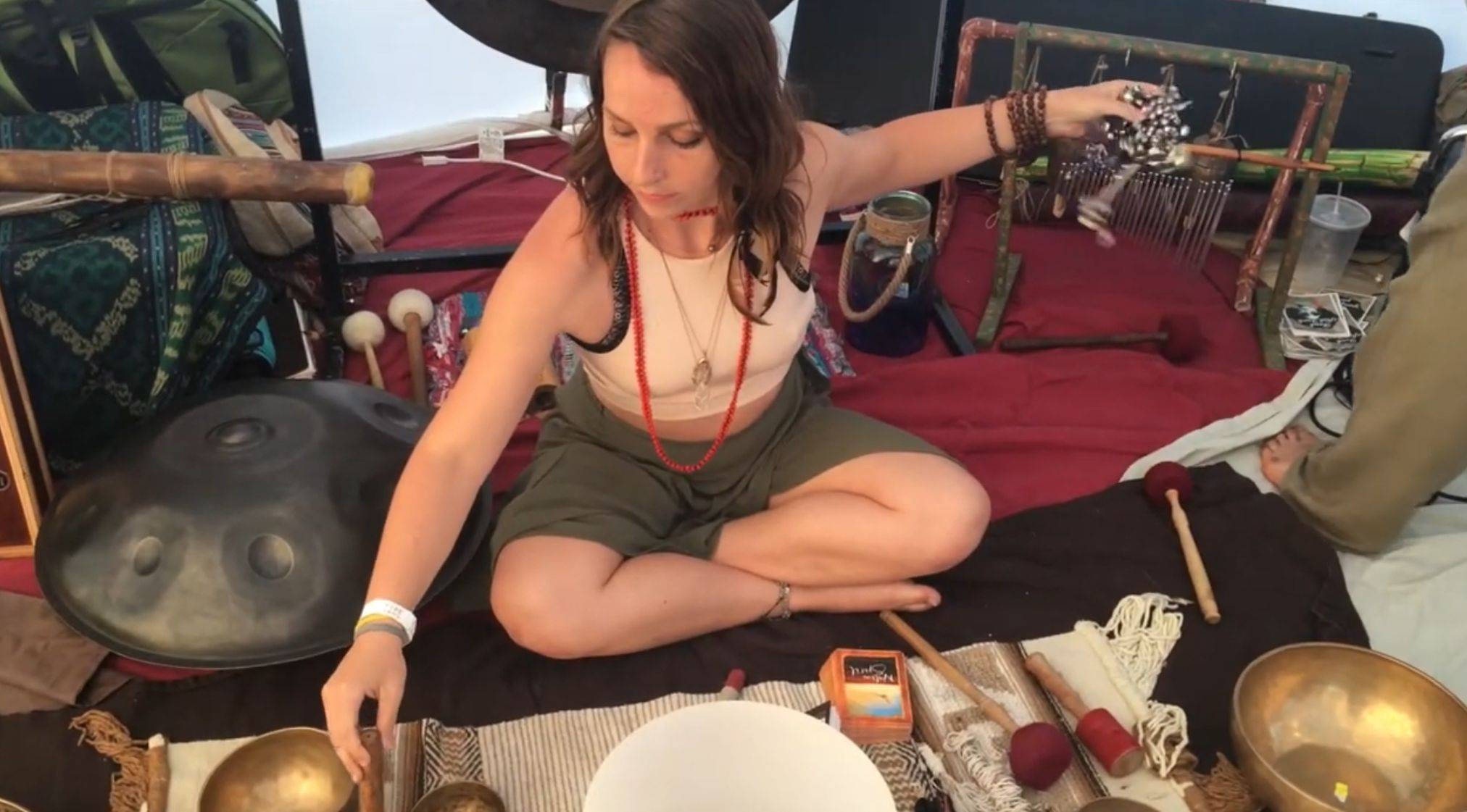 Zosha from Sound Will Heal surrounded by singing bowls and sound healing instruments, special guest at the Hold Me Tight Couples Workshop in Utah