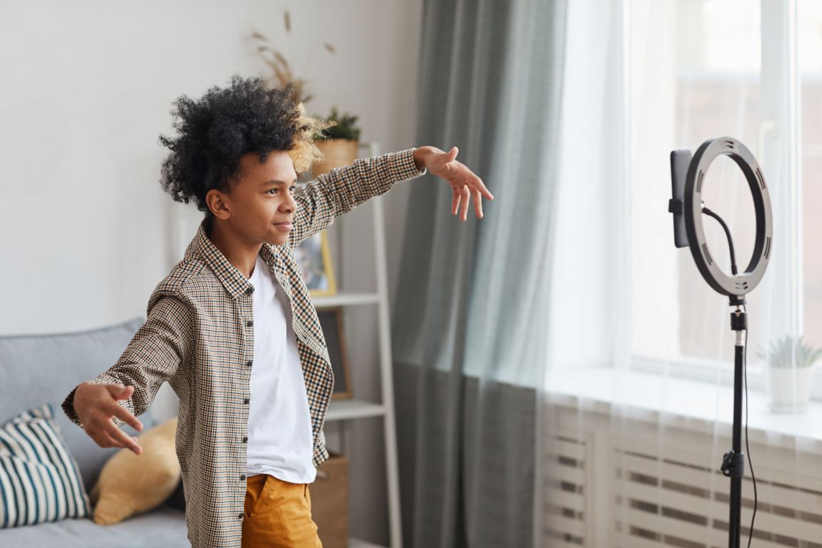 Guy filming himself inside with lighting
