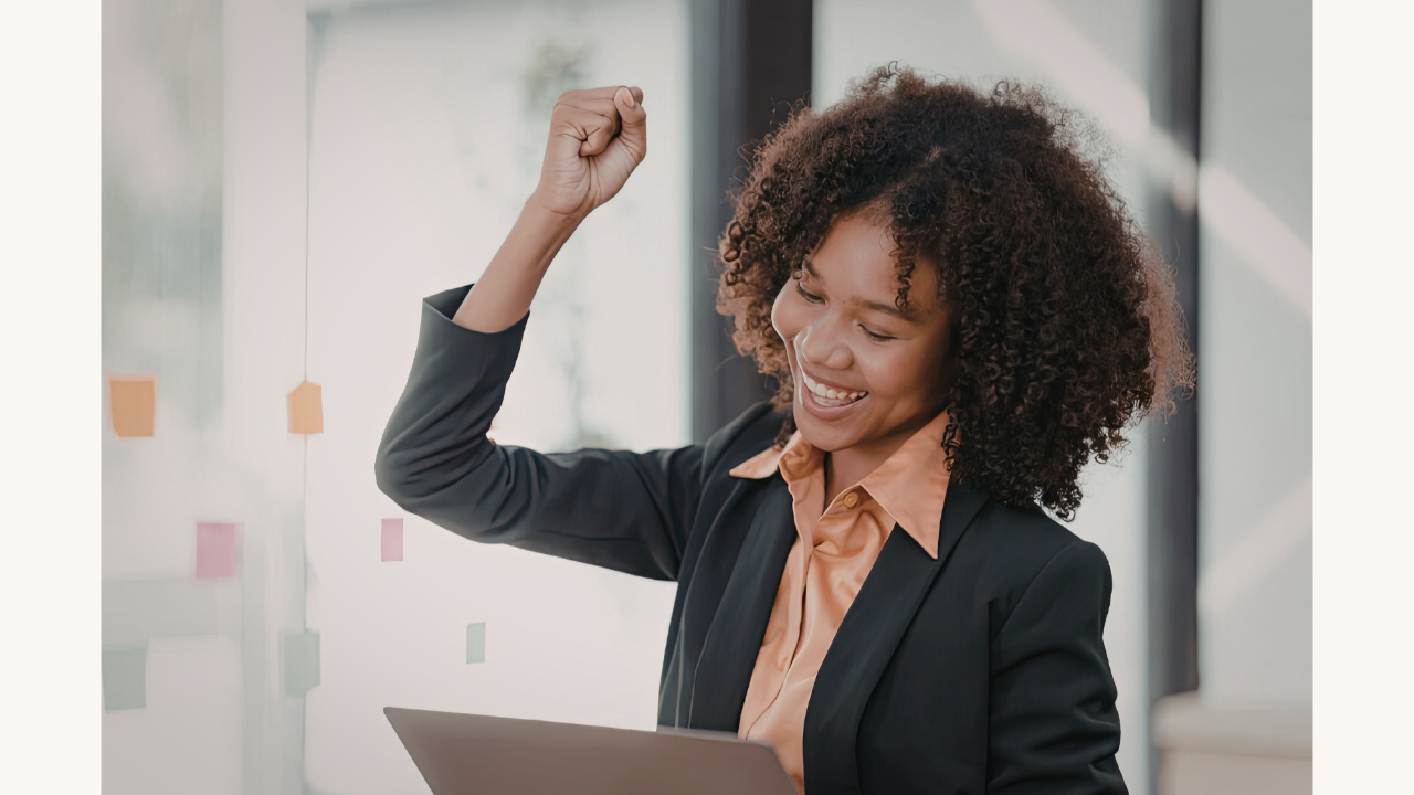 A confident woman at work embodying self-love and authenticity, overcoming imposter syndrome.