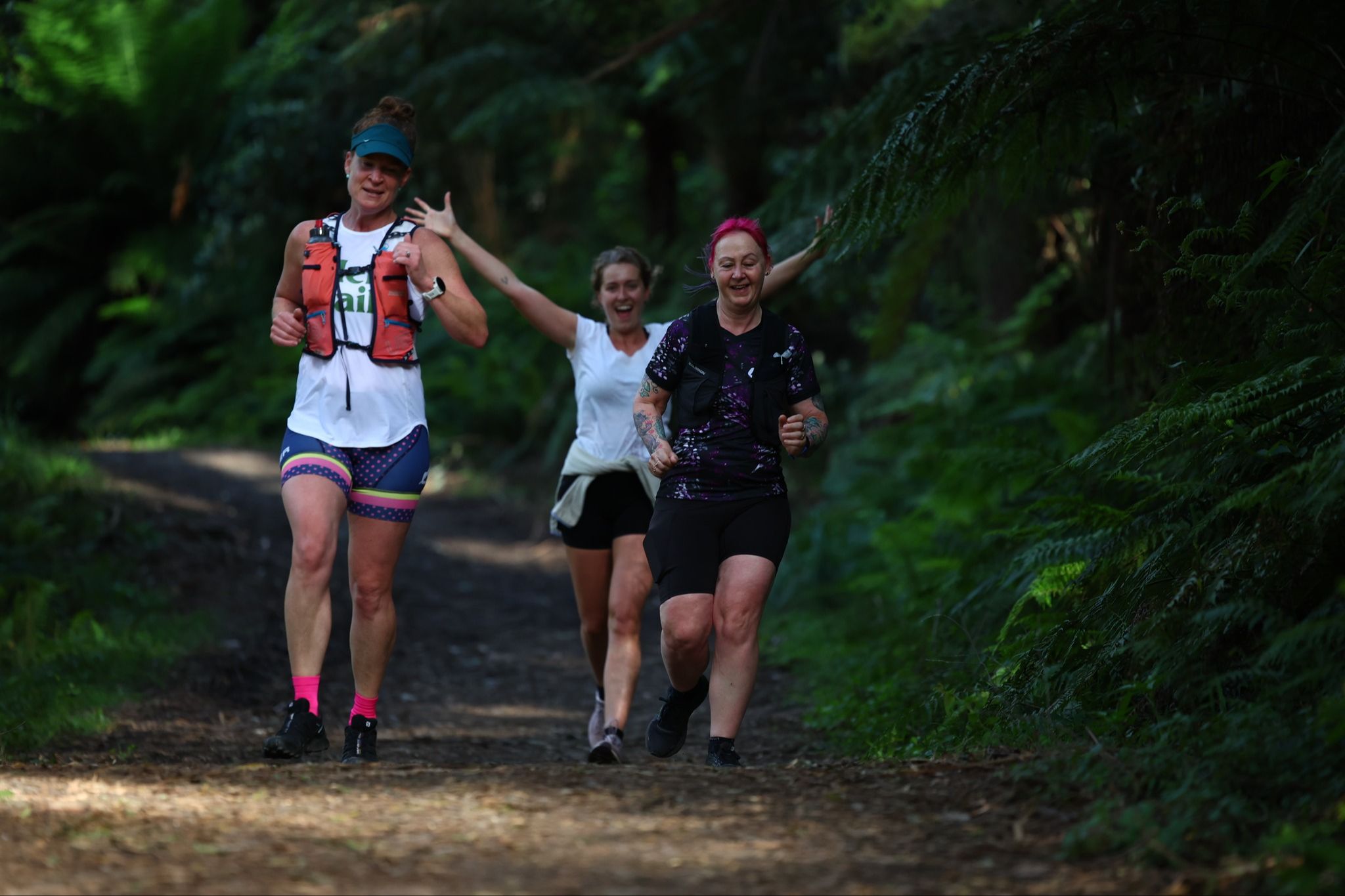 Trail runner checking fitness benchmarks and training progress on a mountain trail