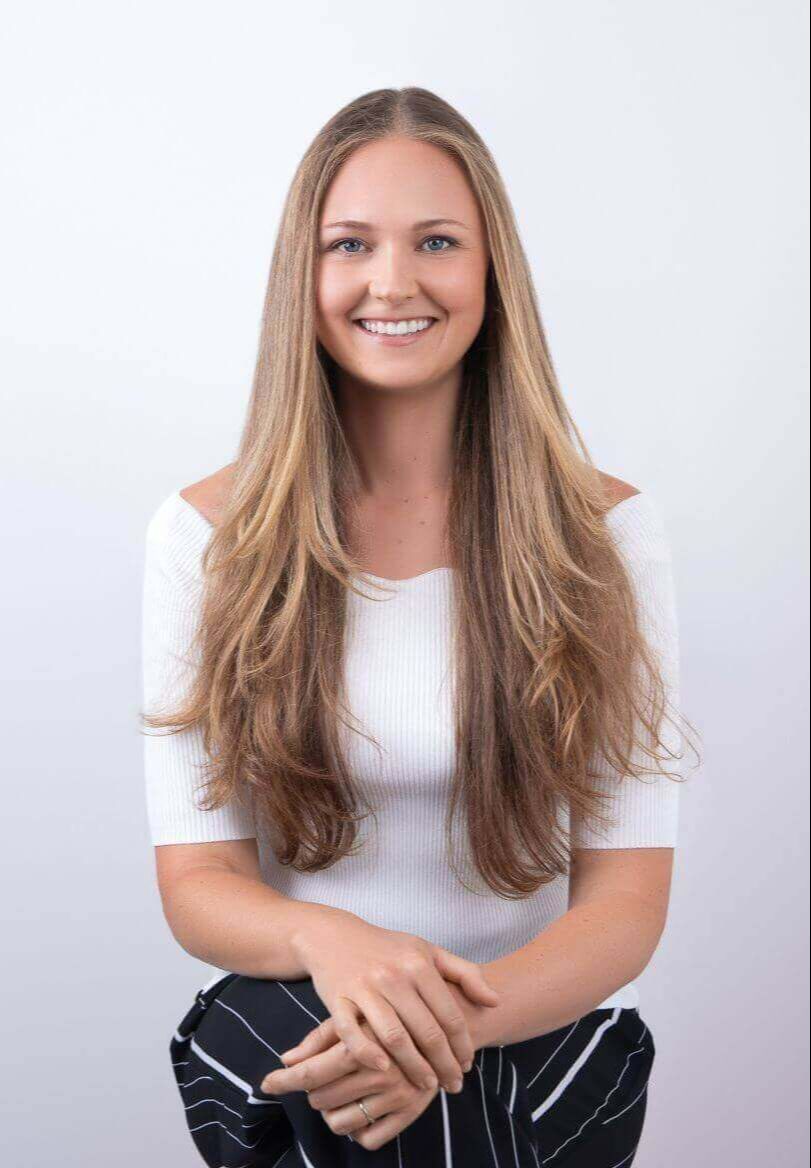 Theresa White, career clarity coach, sparketype advisor, smiling and sitting on white background.