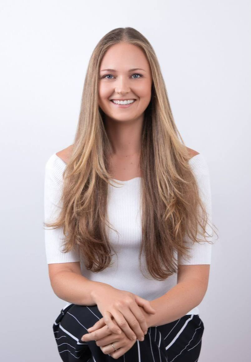 Theresa White, career clarity coach, sparketype advisor, smiling and sitting on white background.