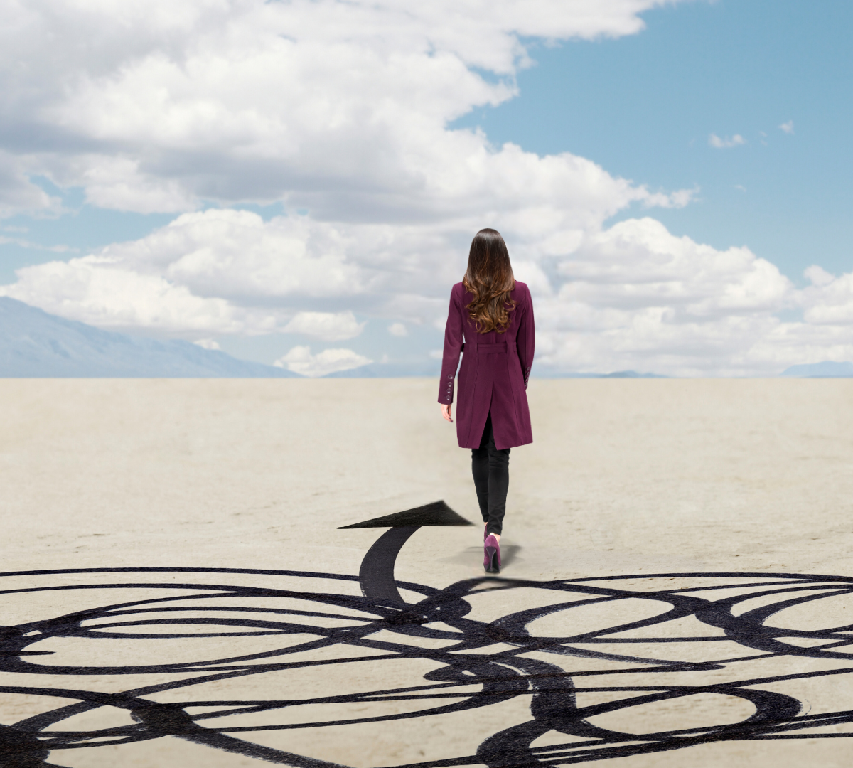 Woman on the other side, walking confidently toward the horizon after gaining career clarity and successfully landing a new career.