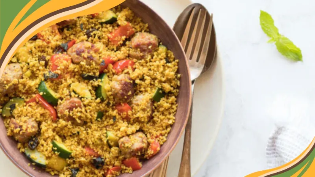 Colorful couscous with sausage, zucchini, and bell peppers served in a bowl for a hearty, healthy meal.