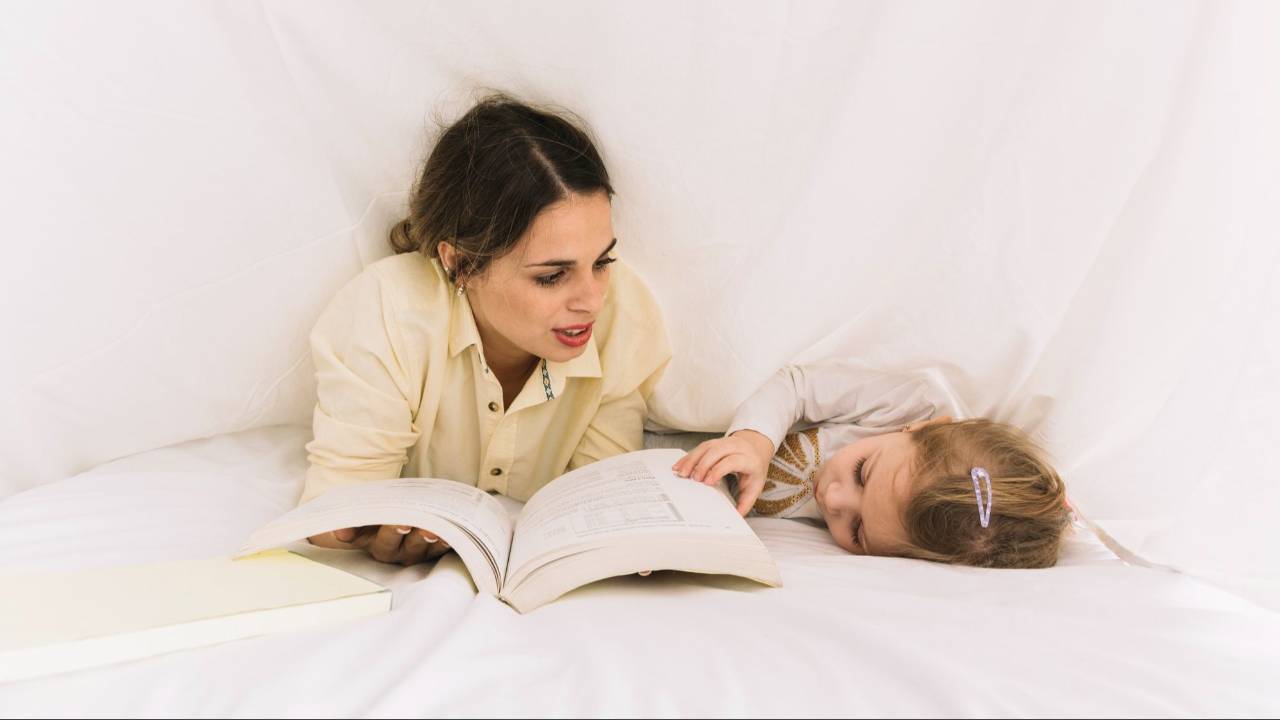 A parent reading a bedtime story to a child who has fallen asleep, as part of a calm bedtime routine