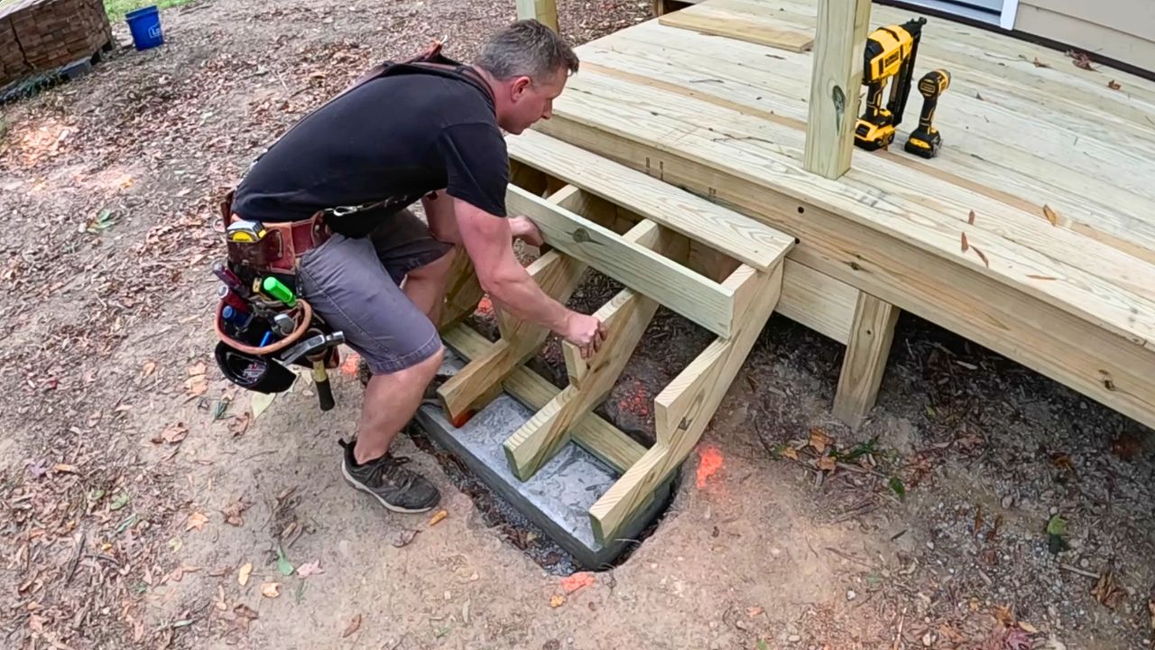 Building deck stairs and setting stringers on a concrete pad
