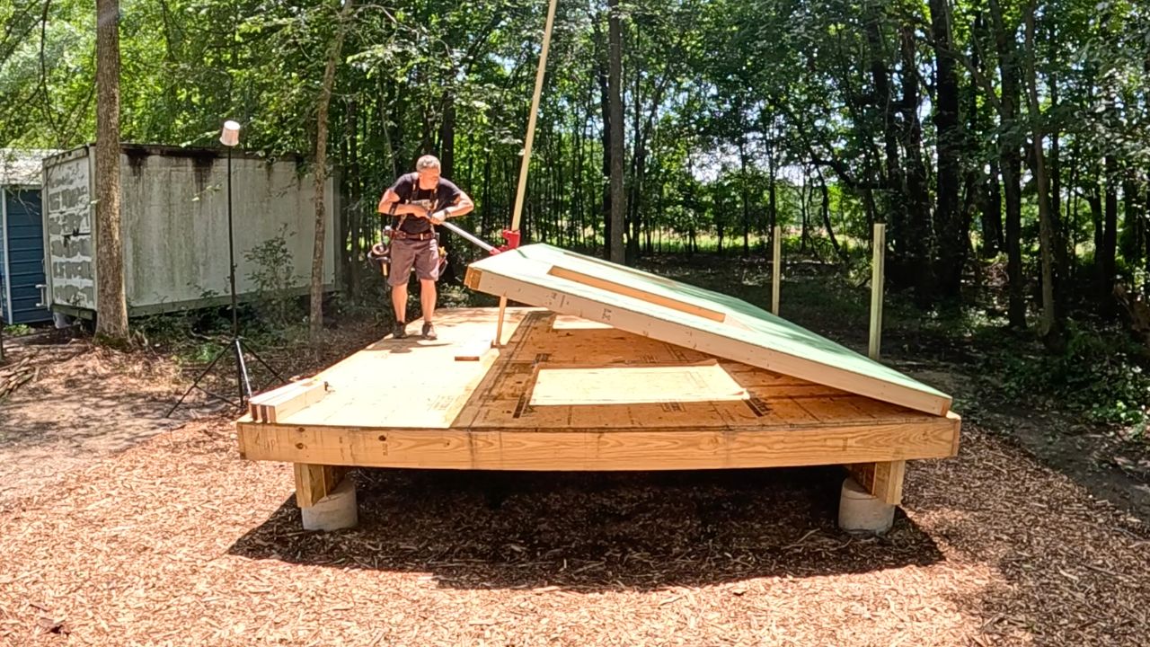 Raising a framed wall on the floor deck