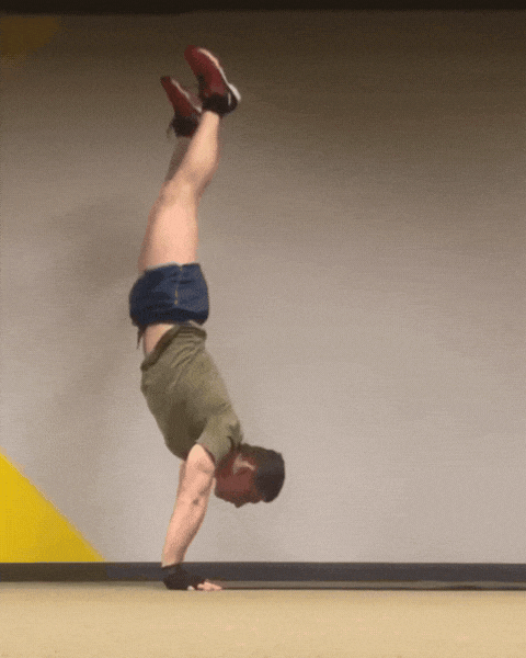 Member doing handstand forward roll