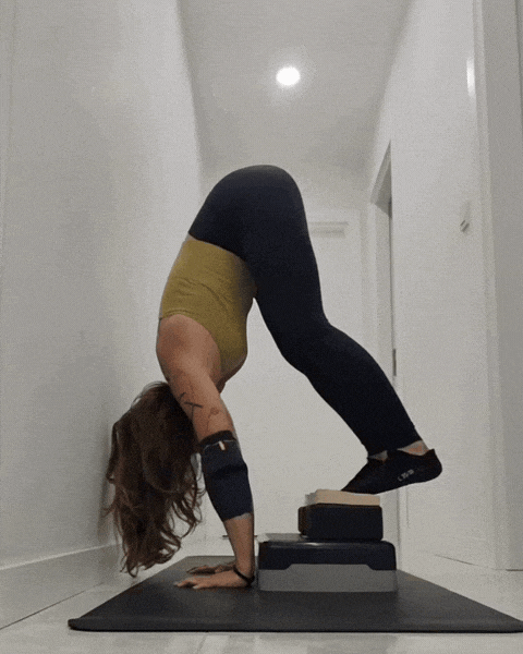 Member doing press handstand