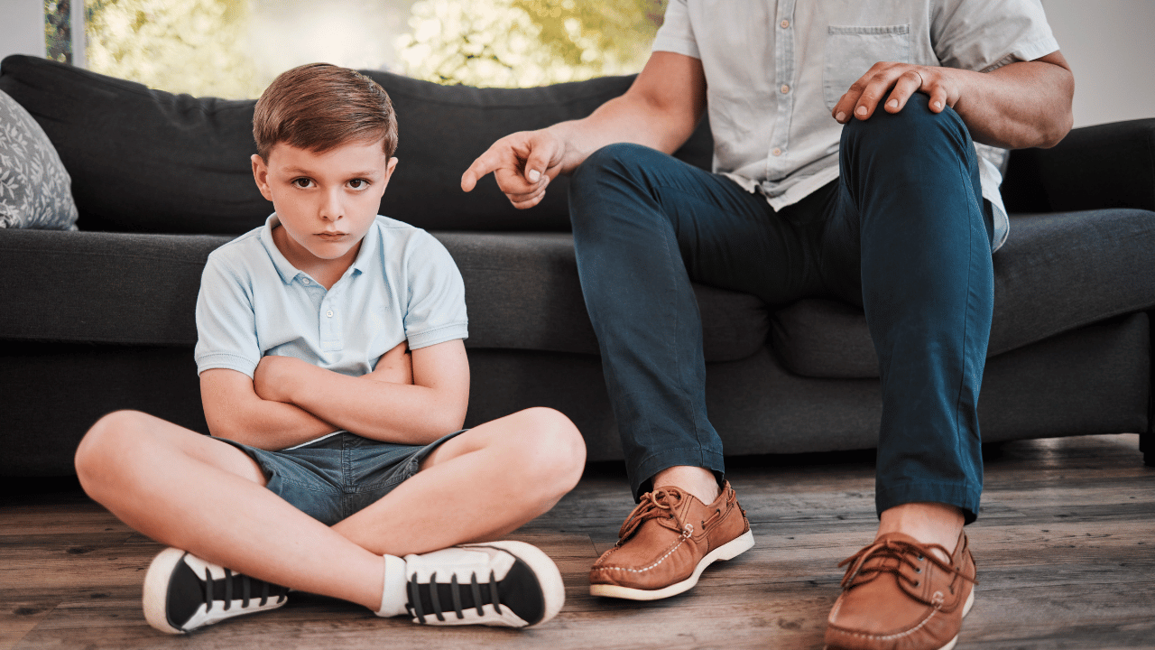 child upset, parent shaking finger at him