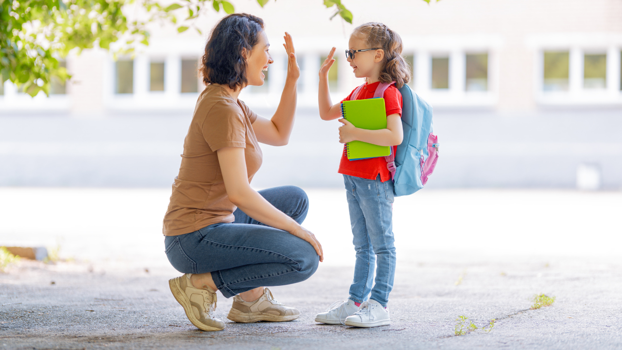 mom high fiving young daughter