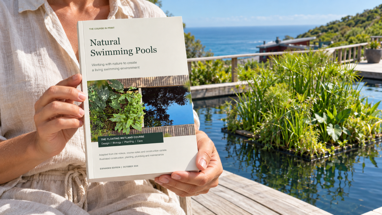 The Natural Swimming Pools e-book beside a floating wetland pool