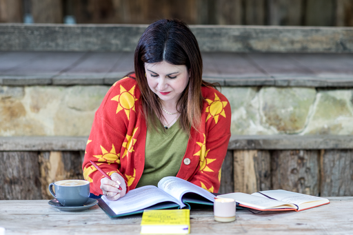 Dr Rosie Gilderthorp writing in a notebook