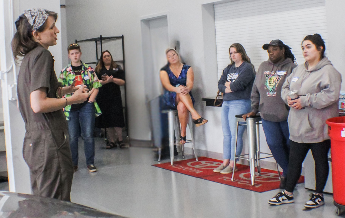 Women learning car care together at the hands-on workshop