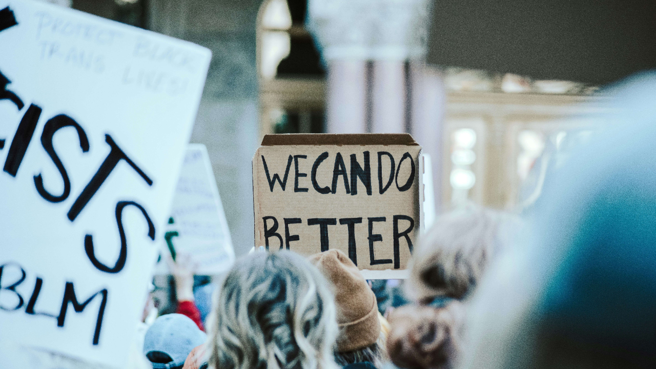 protest with a carboard poster stating 