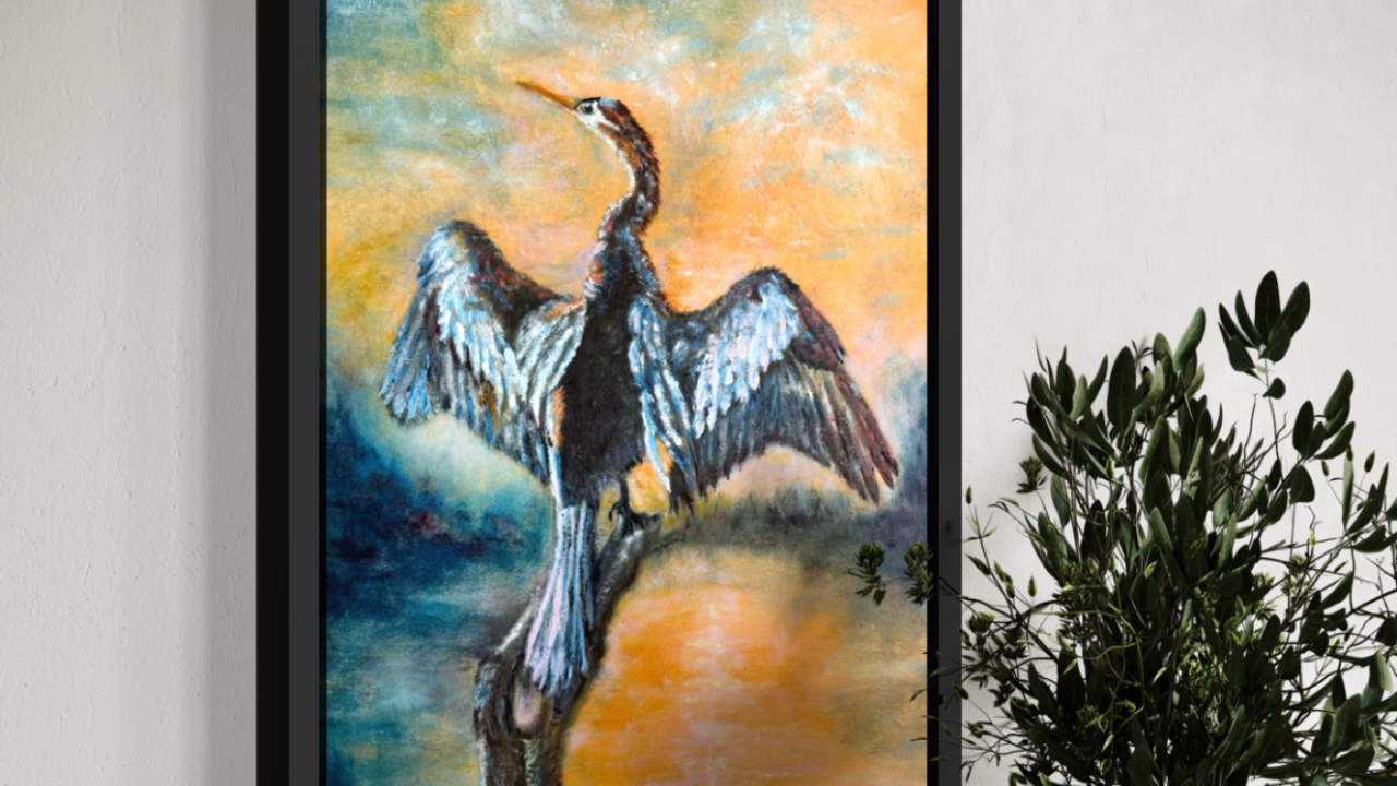 Original oil painting of an anhinga with wings fully spread, drying its feathers against an orange and yellow sunset sky over water, by Florida artist Jenn Royster