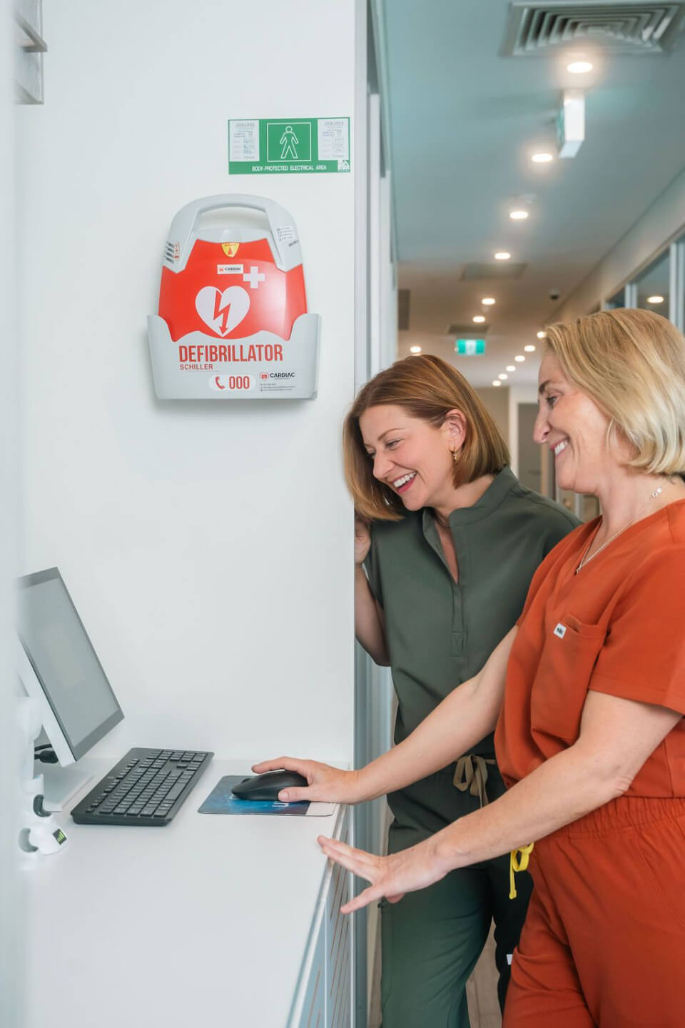 Rochelle Fisher with a dental team member at the computer