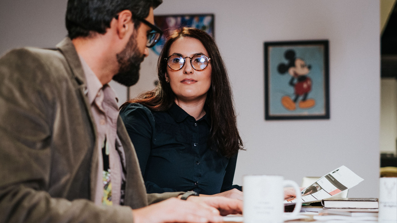 coordinator reviewing project timeline at desk in creative agency