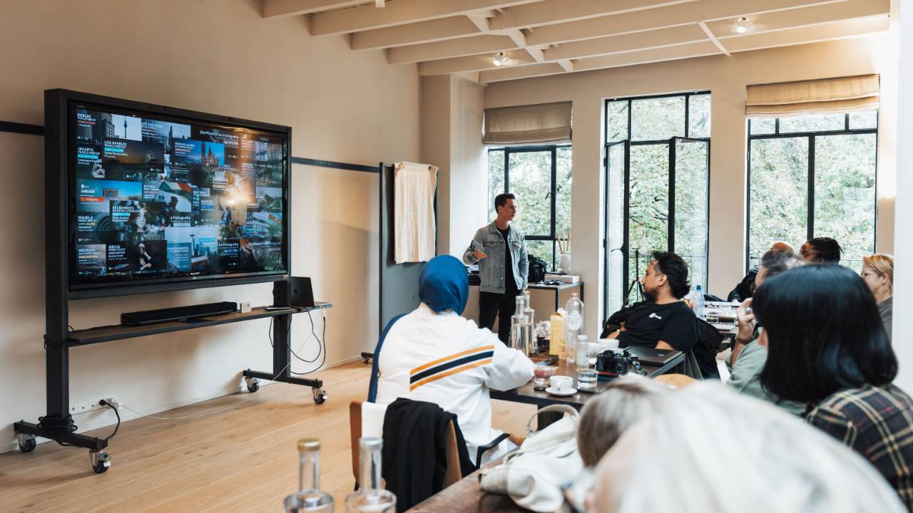 creative team reviewing multiple design concepts on a large screen in a meeting room