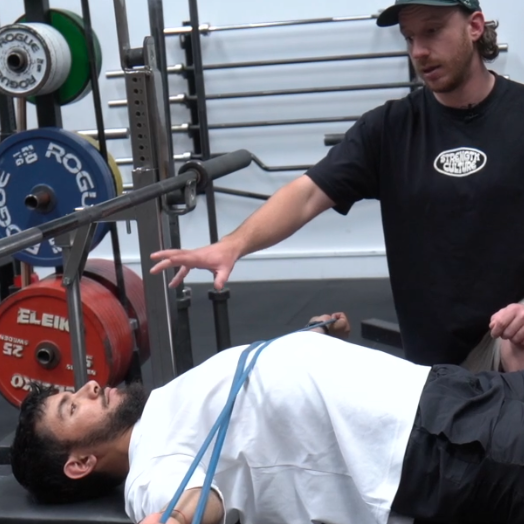 Jamie Smith coaching a client through movement assessment