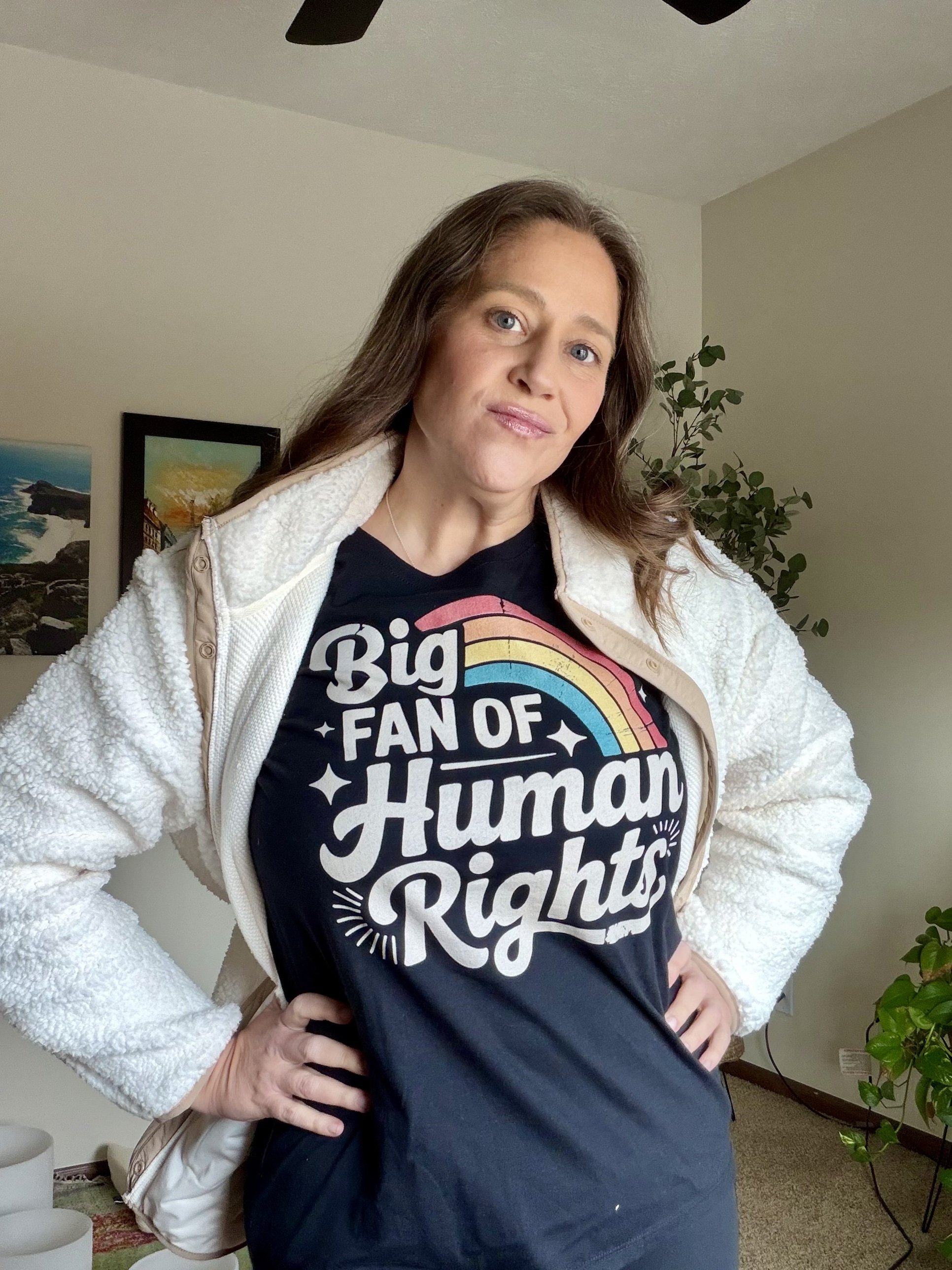 Kara Bunde-Dunn standing with hands on hips in a Big Fan of Human Rights tee