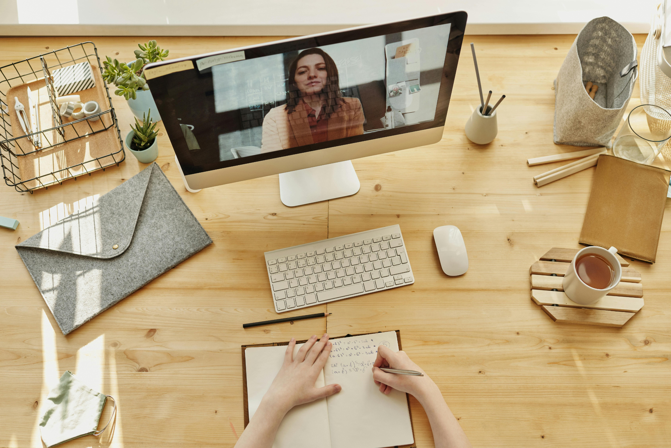 Person engaged in self-paced learning, watching an educational video on a screen.