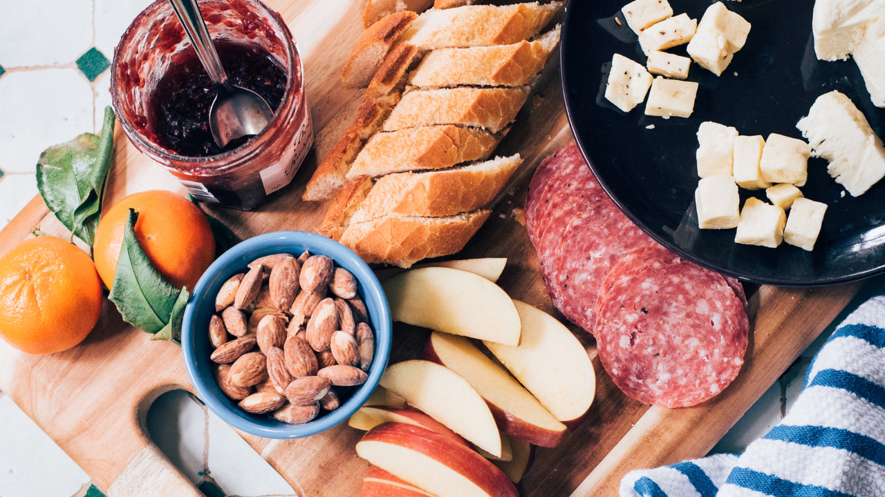 apples, bread, jam, almonds, cheese and pepperoni