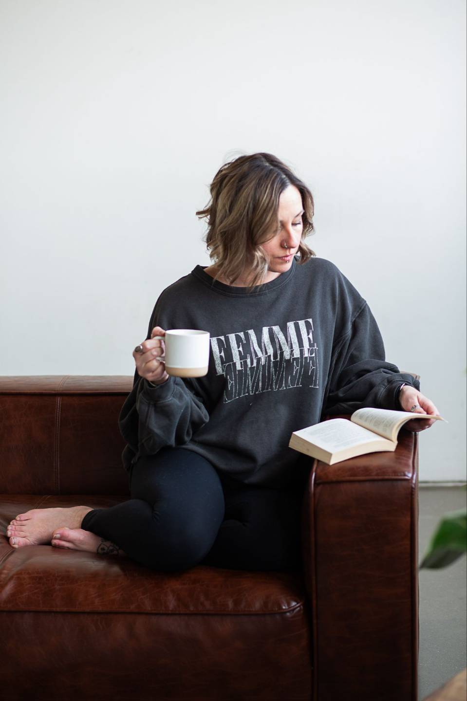 Chelsea reading with a cup of coffee