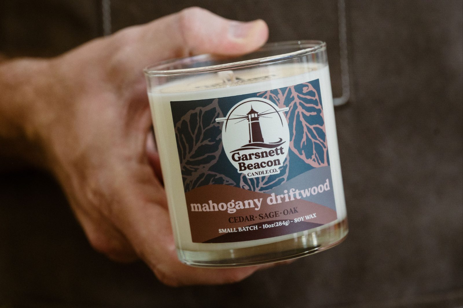 Holding a Garsnett Beacon mahogany driftwood candle