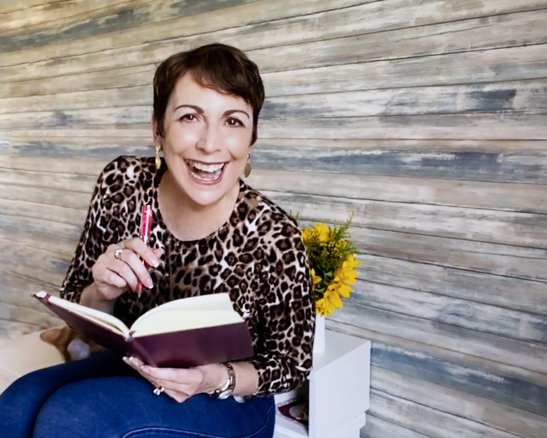 Deanna Fenton laughing with a book