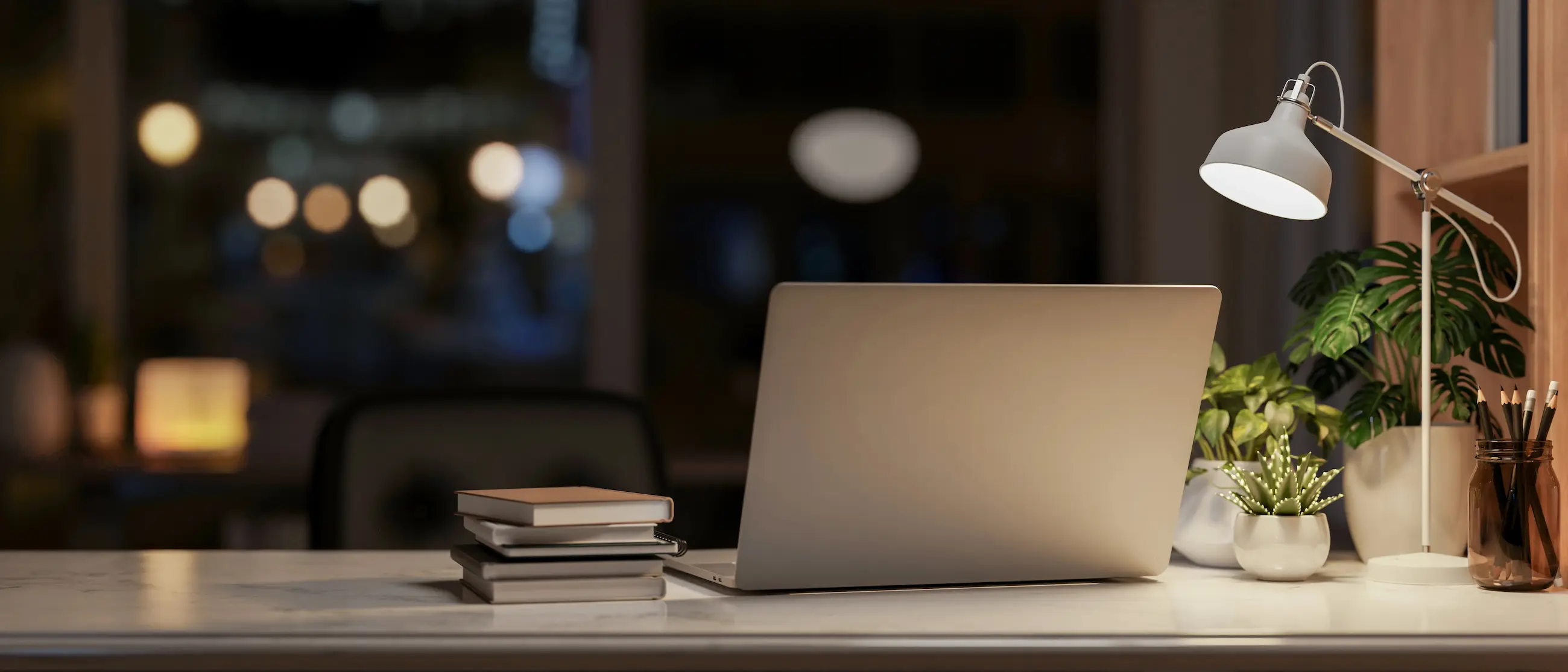 Warm workspace with laptop and lamp