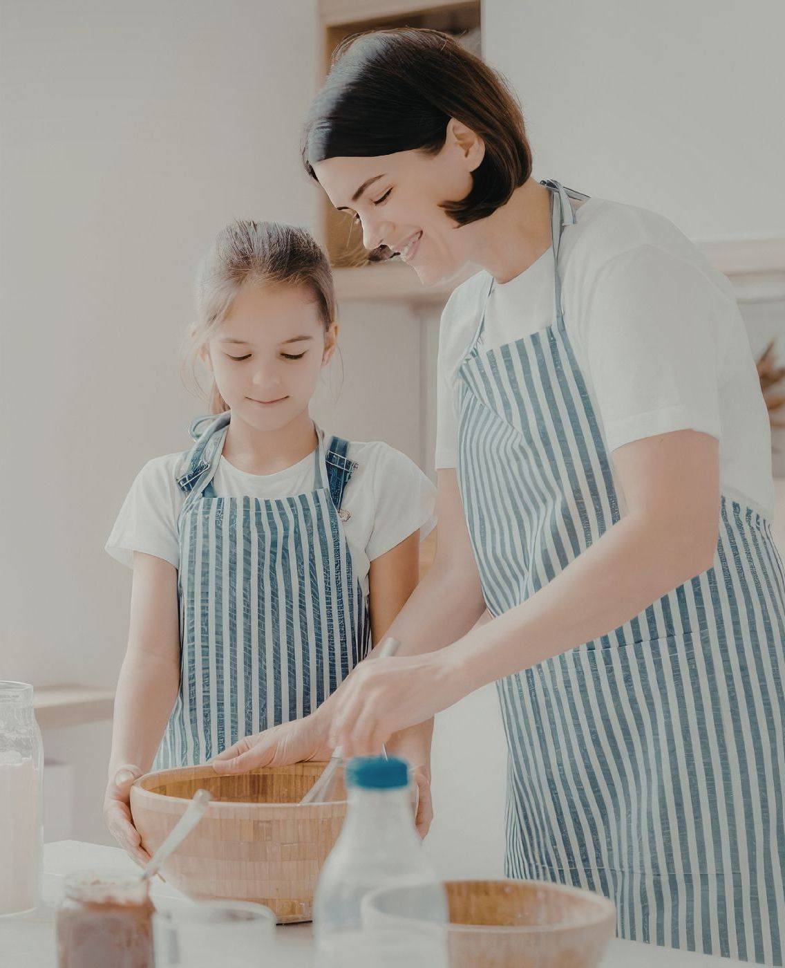 Mother and daughter cooking together in the kitchen
