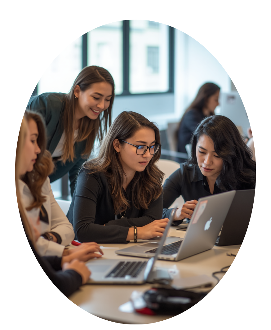 Women working together around a laptop in a creative workspace 
